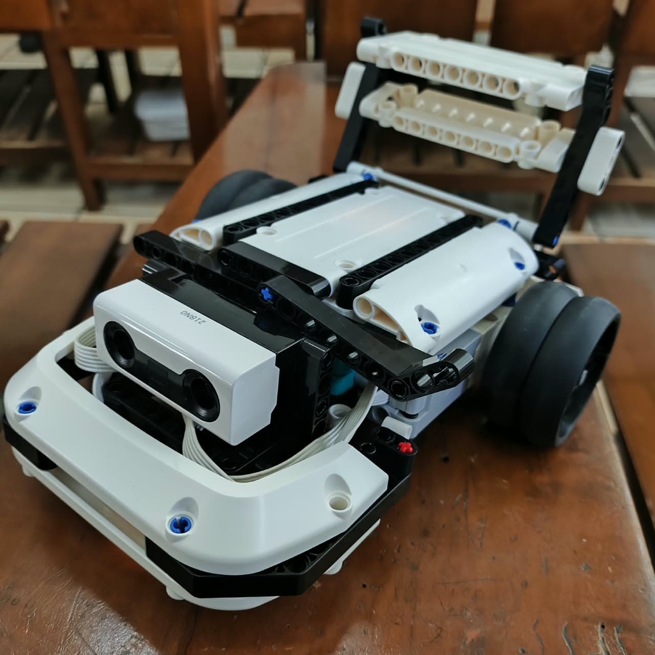 LEGO Robot Inventor maze solver with an ultrasonic sensor in its front bumper